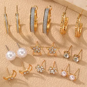 Gold-colored multi-piece earring set featuring hoops, pearls, stars, and rhinestones for women.