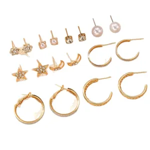 Gold-tone stud and hoop earring set featuring stars, moons, pearls, and sparkling rhinestones.