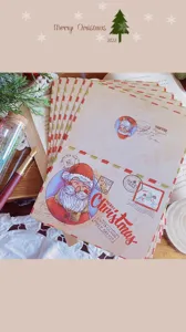 Close-up of vintage kraft Christmas cards with Santa Claus illustrations and envelopes
