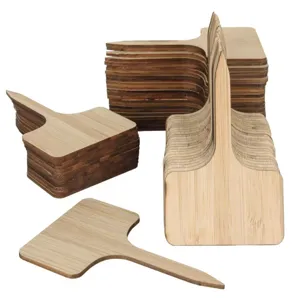 Multiple stacks of T-shaped natural bamboo plant labels showing fine wood grain texture
