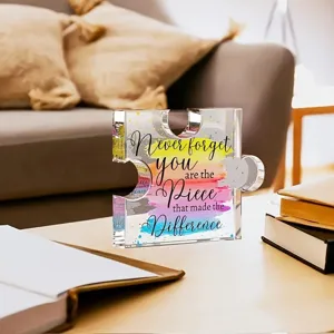 Souvenir en acrylique pièce de puzzle avec citation sur table