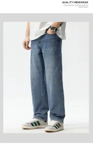 Detailed view of men's loose fit straight leg denim jeans in vintage blue washed denim