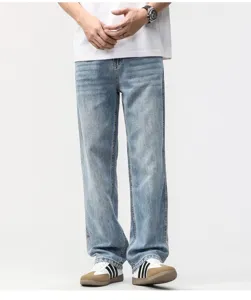 Model wearing men's vintage light blue wide-leg straight denim jeans in a studio