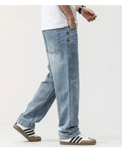 Side view detail of men's loose straight-leg retro denim jeans in light blue wash