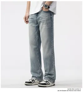 Detail view of men's loose straight-leg denim jeans in vintage washed light blue finish