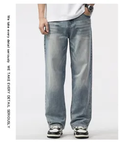 Detail of men's vintage loose fit straight leg denim jeans with washed blue finish