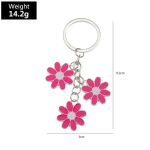 Metal keychain featuring charming pink flower enamel pendants, stylish accessory for keys and bags.
