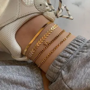 Gold layered anklet set with sparkly letter pendant for women chic foot jewelry accessory detail.