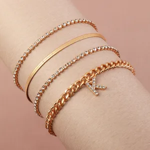 Detailed close-up view of a 4-piece gold tone rhinestone letter K anklet and bracelet set.