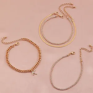 Gold rhinestone letter K anklet set, 4-piece fashion jewelry for women daily wear.