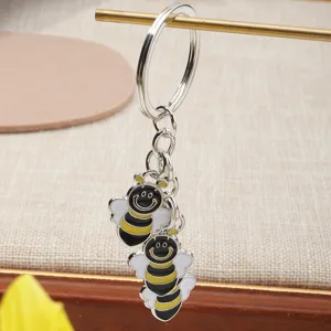 Metal bee keychain with cute enamel smiling insect charms, polished silver keyring for keys.
