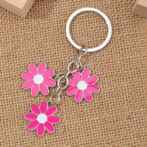 Metal alloy keychain featuring cute pink and white flower pendants, perfect for keys.