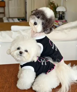 Cute black dog vest with pink heart and white trim, breathable summer pet apparel for small dogs.