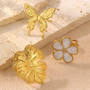 Detailansicht retro Edelstahlringe mit Schmetterling, Blatt und Emaille Blume Motiven.