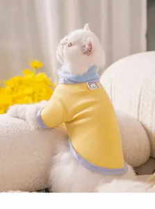 Cozy pet warm base shirt detail shot featuring soft yellow fabric and cute blue collar scarf design.