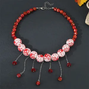 Detailed shot of Halloween red and white beaded choker necklace with tassels for women.