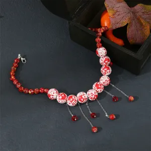 Halloween red bead tassel choker necklace, stylish spooky holiday jewelry detail shot.