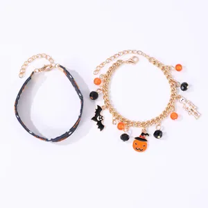 Set bracciali Halloween con cinturino in tessuto e catena dorata ciondoli zucca e dettagli