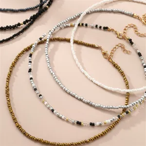 Bohemian seed bead layered necklace set detail, delicate multi-strand choker jewelry design.