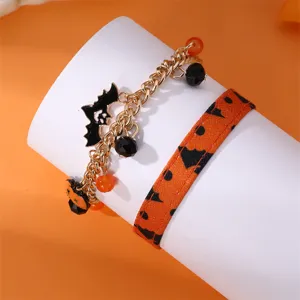 Set di bracciali di Halloween con catena dorata, ciondoli a zucca e cinturino in tessuto.
