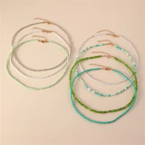 Detailed view of bohemian seed bead choker necklaces set featuring various vibrant green and white tones.