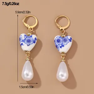 Vintage blue and white porcelain heart pearl drop earrings with gold tone lever back loops.