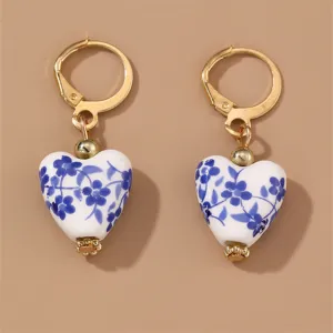 Vintage blue and white porcelain heart earrings, elegant gold-toned leverback fashion jewelry.