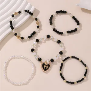 5-teiliges schwarz-weisses Perlenarmband Set mit Herz-Schleife Anhänger Modeschmuck