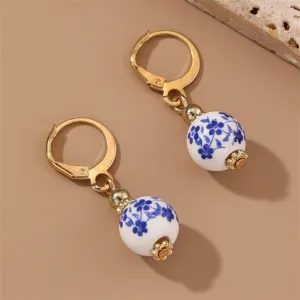 Vintage blue and white porcelain floral bead dangle earrings with gold-toned metal leverbacks.
