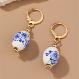 Retro Chinese style blue and white porcelain earrings with alloy gold-tone dangle beads.