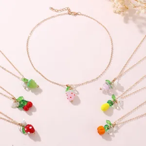 Close-up detail of colorful resin fruit necklaces featuring cute strawberry cherry grape designs.