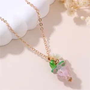 Detailed close-up of a charming gold chain necklace with colorful resin grape pendant and flower.