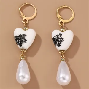 Retro gold-tone drop earrings with white ceramic heart beads and faux pearl pendants.