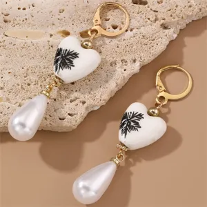 Vintage porcelain heart earrings with faux pearl teardrop charms and gold leverback.
