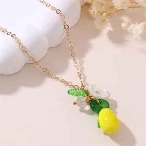 Chic gold chain necklace featuring colorful resin fruit and flower pendant detail, stylish accessories.