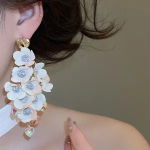 Detailed close-up of Korean fabric flower tassel earrings, showcasing multi-layer floral design.
