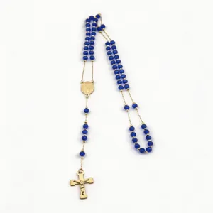 Elegant 6mm faceted blue bead rosary necklace with a gold cross and devotional medal.