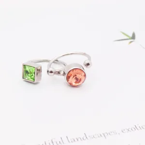 Minimalist titanium steel open rings with square green and round peach crystal stones.