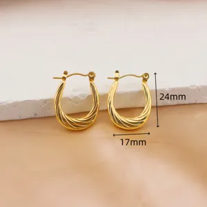 Gold plated stainless steel twist hoop earrings, detail shot displaying 24x17mm size.