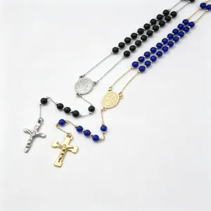 Detailed close-up view of religious rosary necklaces featuring elegant crucifixes and beads.
