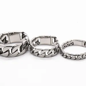 Close-up detail of men's chunky titanium steel curb chain jewelry in polished silver tone.
