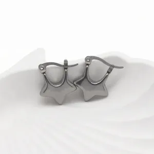 Close-up detail of minimalist star stainless steel hoop earrings in dark metal tone.