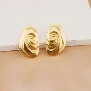 Gold-plated abstract swirl drop earrings chic metal jewelry detailed close up view.