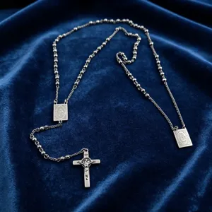 Stainless steel rosary bead necklace with crucifix cross pendant, vintage religious style detail.