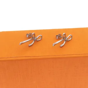 Minimalist stainless steel ribbon bow stud earrings for women, versatile niche design jewelry.