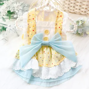 Cute summer dog dress with yellow polka dots, blue bow and white lace for small pets and puppies.