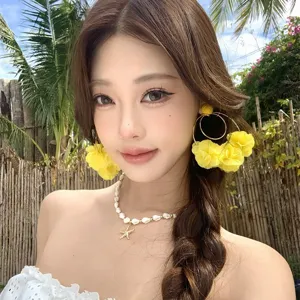 Exquisite yellow fabric flower hoop earrings detail view, perfect for resort vacation style.
