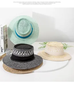 Detailed view of hand-woven straw hat, featuring color-blocked dented top and wide brim for summer.