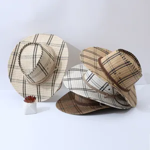 Detailed view of men's summer plaid straw hat showing wide brim and woven texture.
