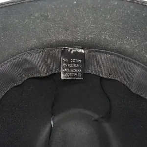 Close-up detail of the black fedora inner wash label showing fabric composition and care info.